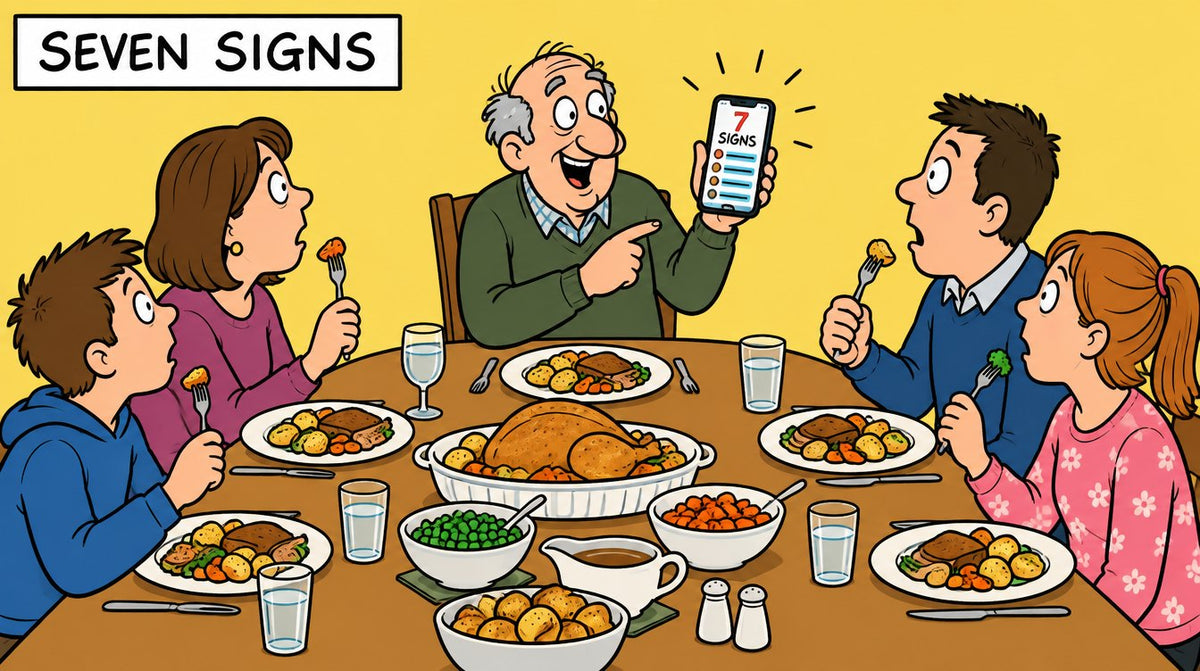 Cartoon of a family Sunday lunch frozen mid-forkful as the grandad at the head of the table holds up his phone, labelled Seven Signs