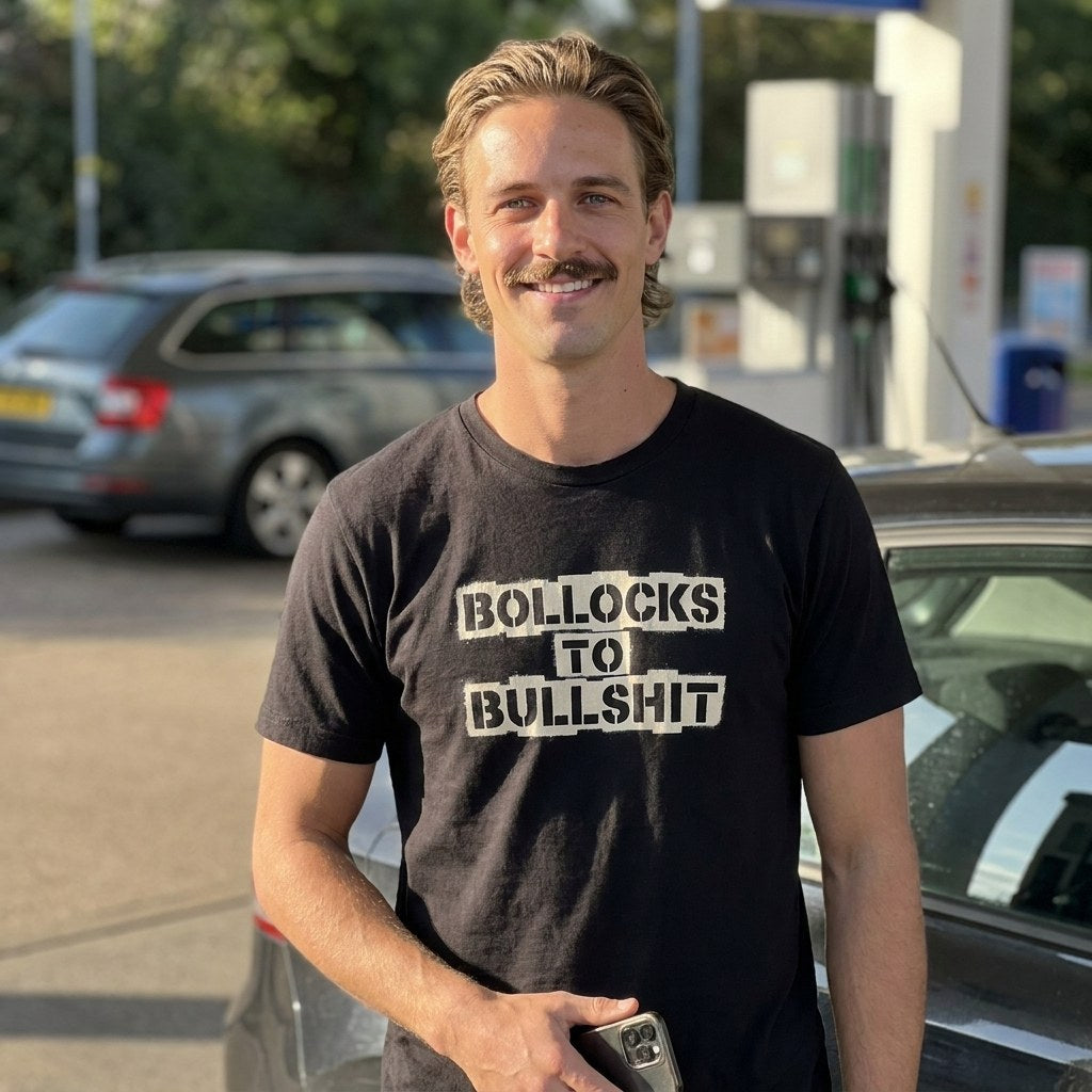 Man in a black Bollocks to Bullshit t-shirt on a garage forecourt