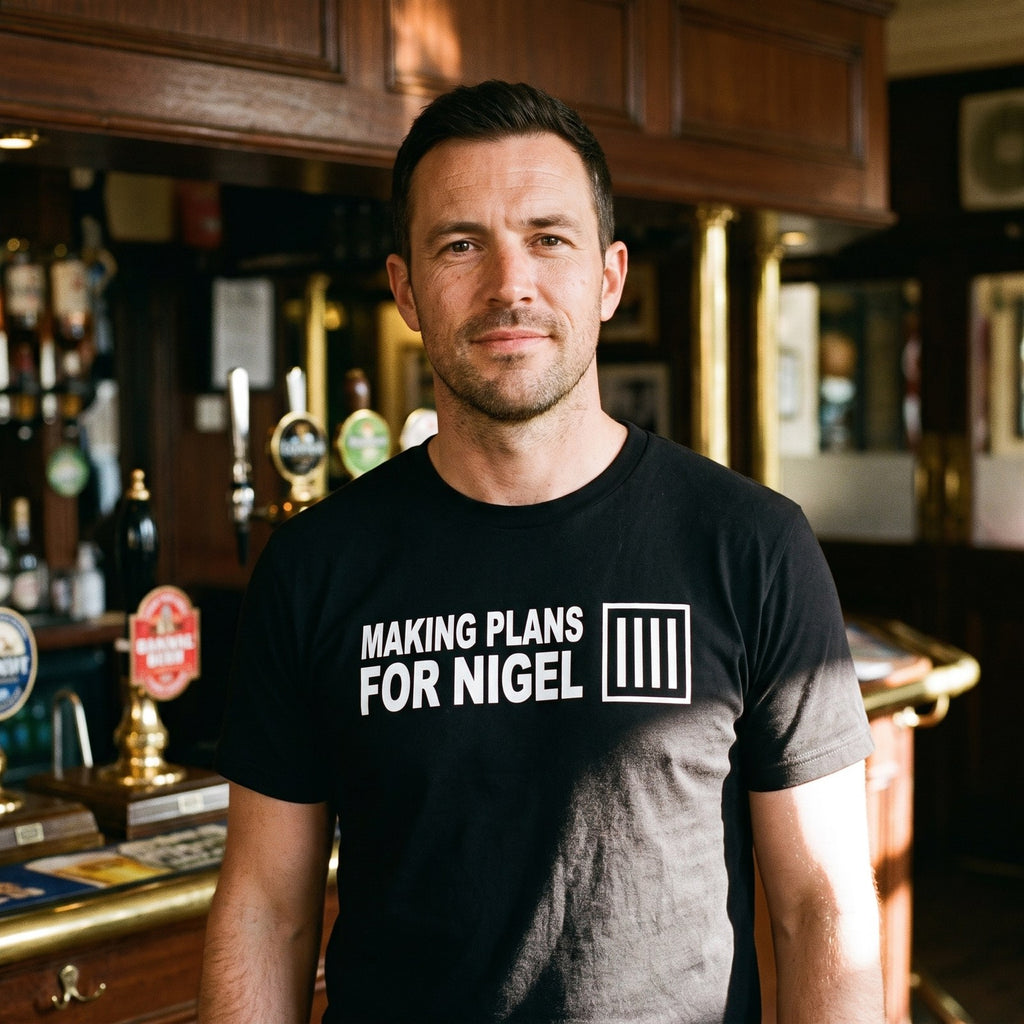 Man in a black Making Plans for Nigel t-shirt in a British pub