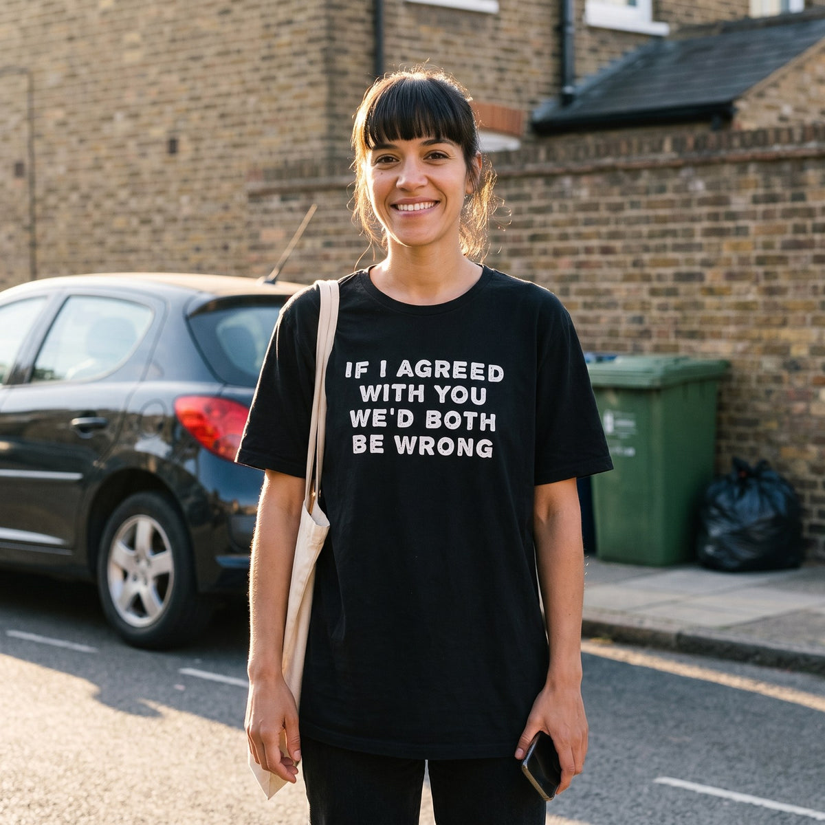 Woman in a black If I Agreed With You We'd Both Be Wrong t-shirt on a terrace street