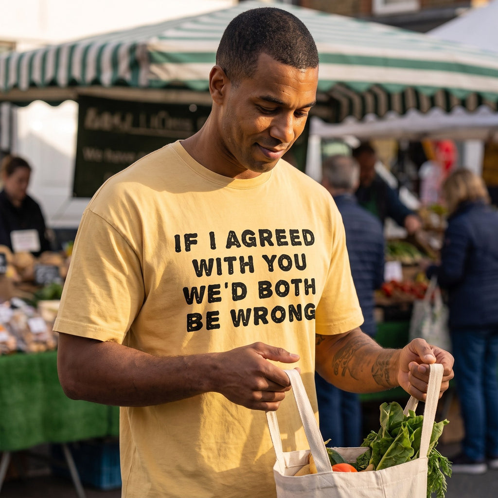 Man in a yellow If I Agreed With You We'd Both Be Wrong t-shirt at a farmers market