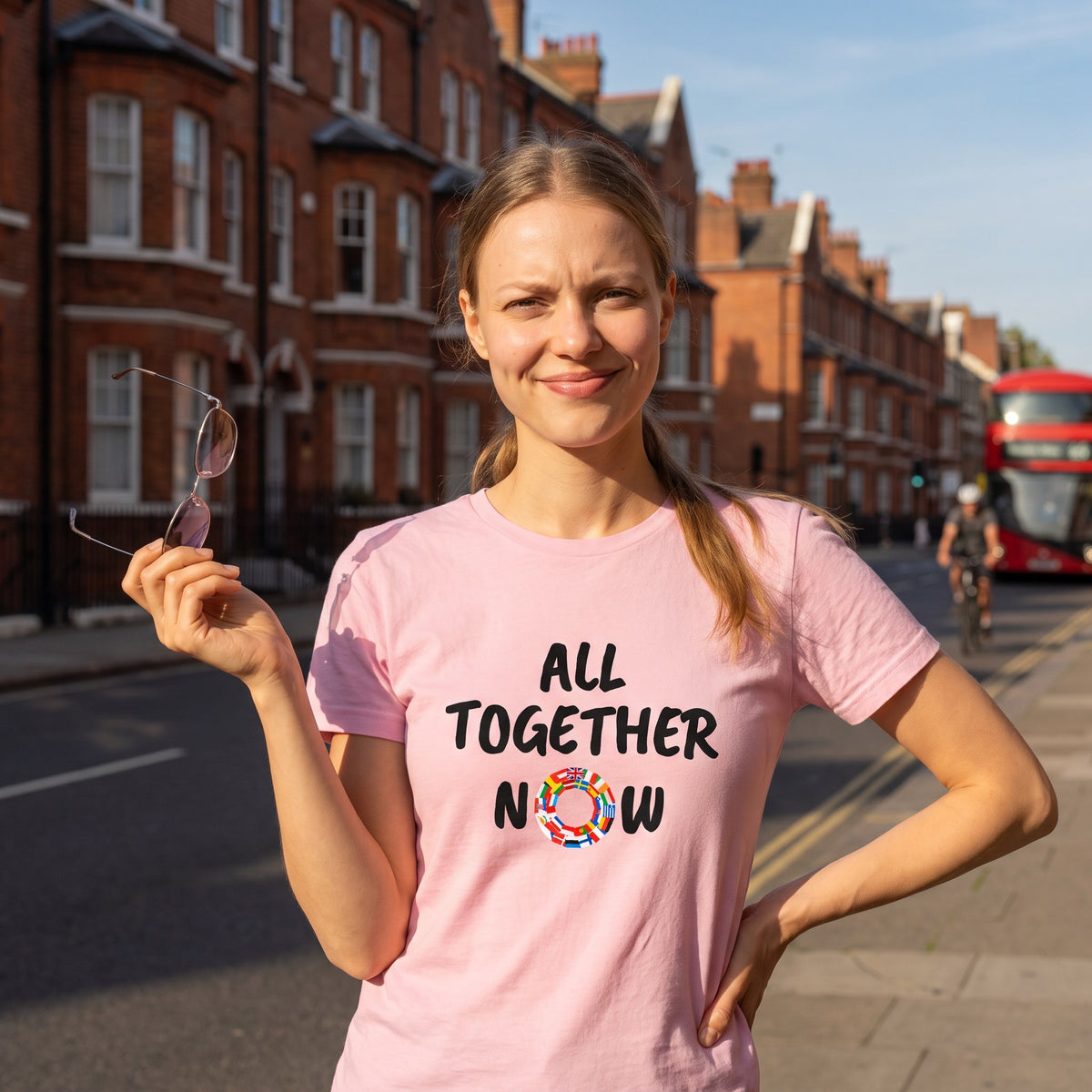 Woman on a city street wearing the pink All Together Now pro-EU t-shirt