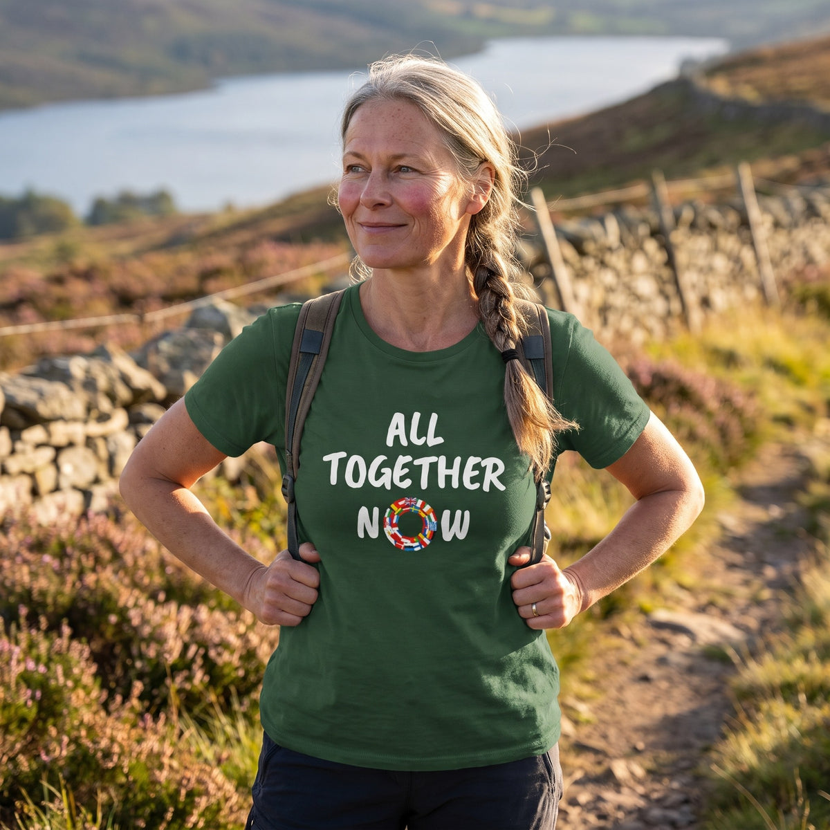 Woman on a Scottish hillside wearing the forest green All Together Now t-shirt