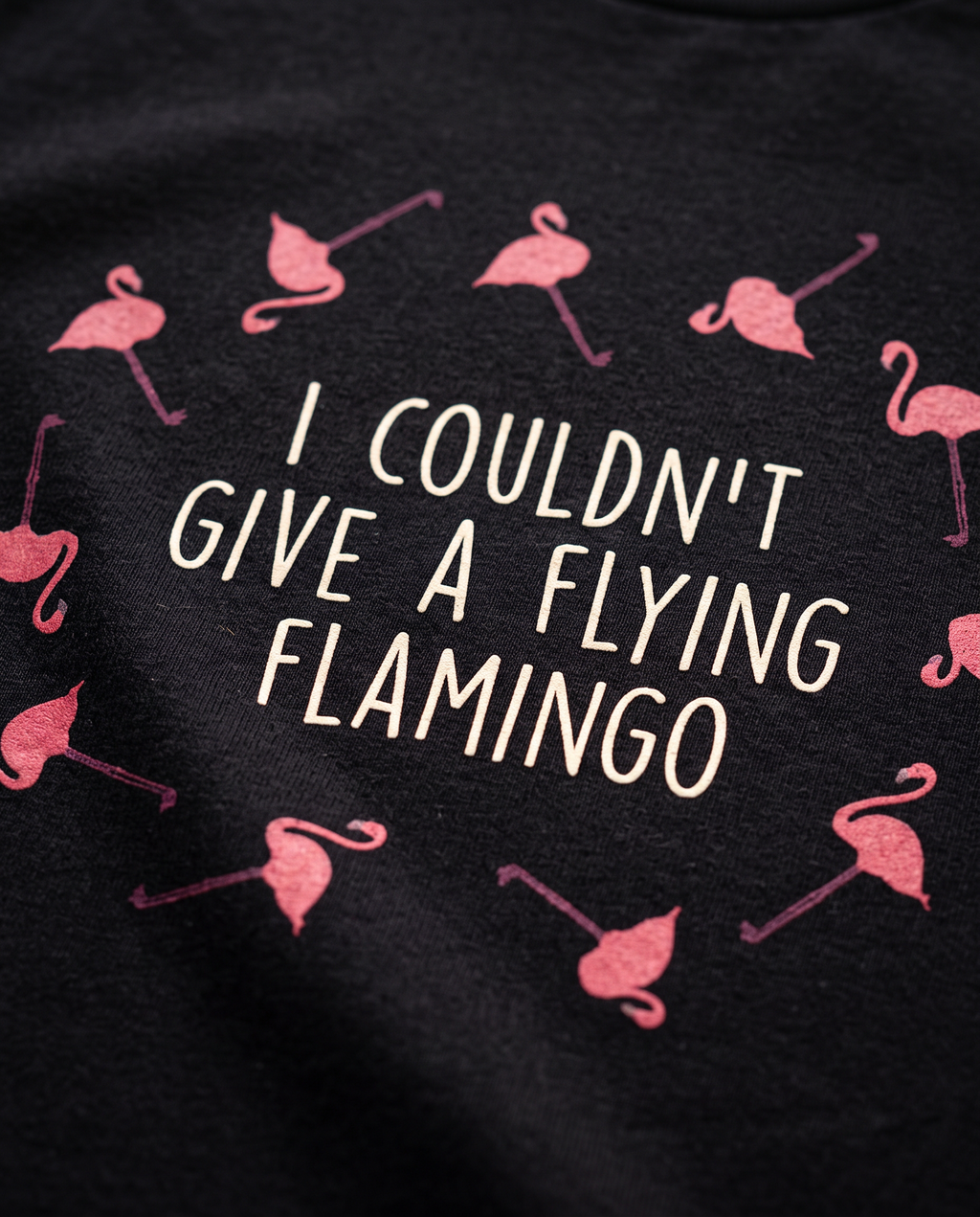 Macro close-up of the Flying Flamingo print on the black t-shirt, showing cotton texture and screen-printed ink detail, Very Brexit Problems