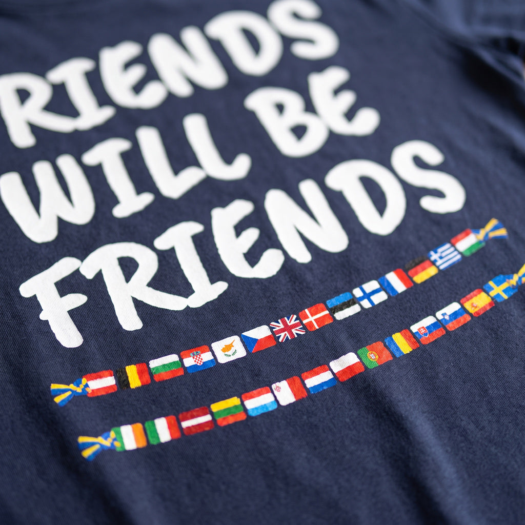 Close-up of the Friends Will Be Friends print: two friendship-bracelet strings of European flags on navy cotton