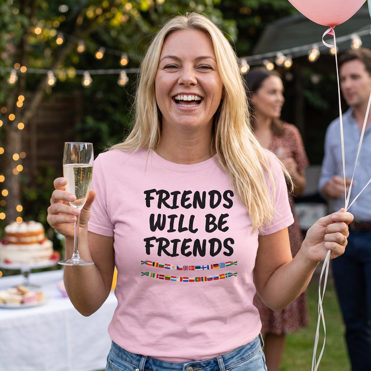 Woman at a garden party in a pink Friends Will Be Friends t-shirt with black print