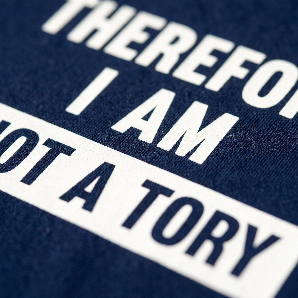 Close up of the white ink I am not a Tory print on navy cotton, showing the fabric weave