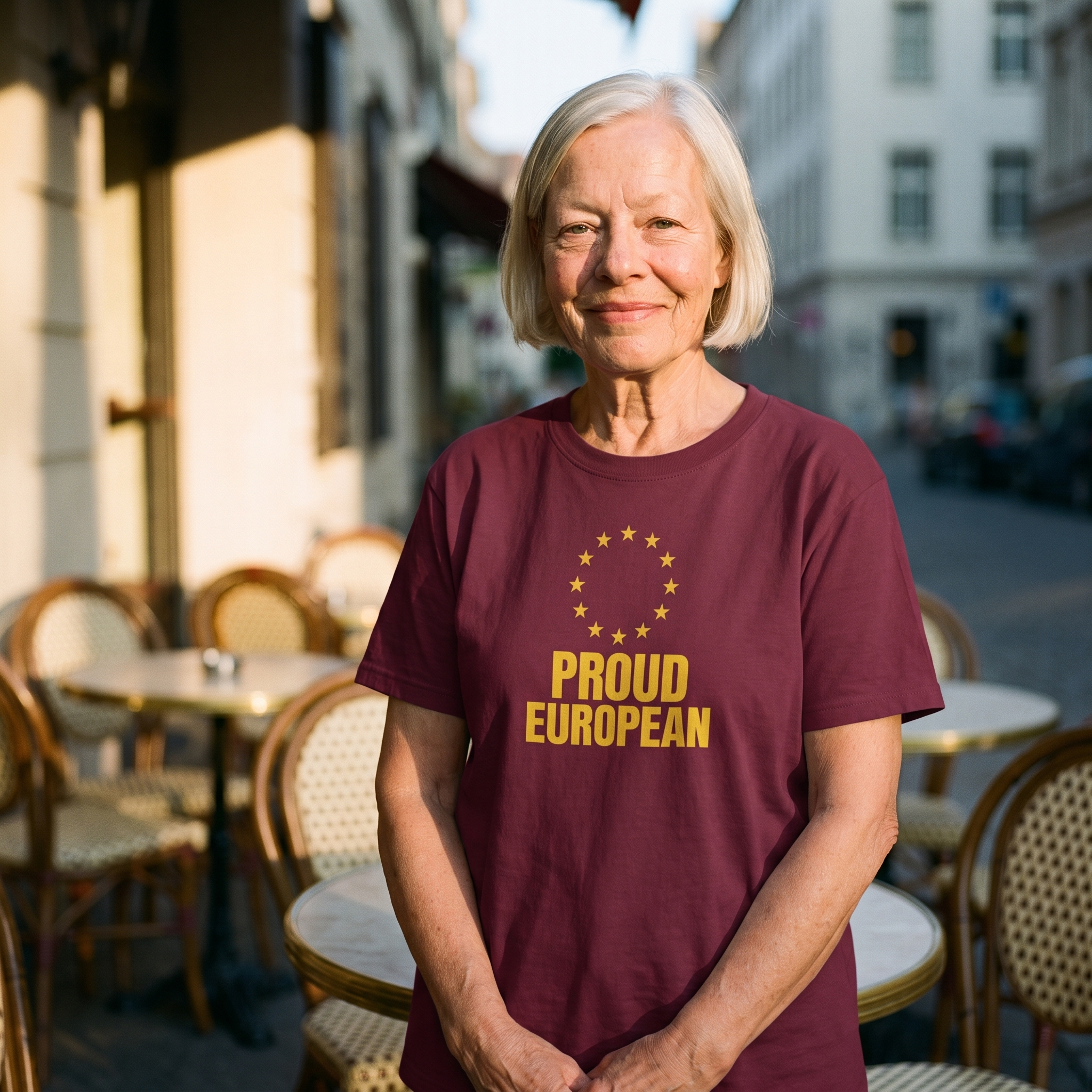 Woman in a maroon Proud European t-shirt at a continental cafe table, Very Brexit Problems
