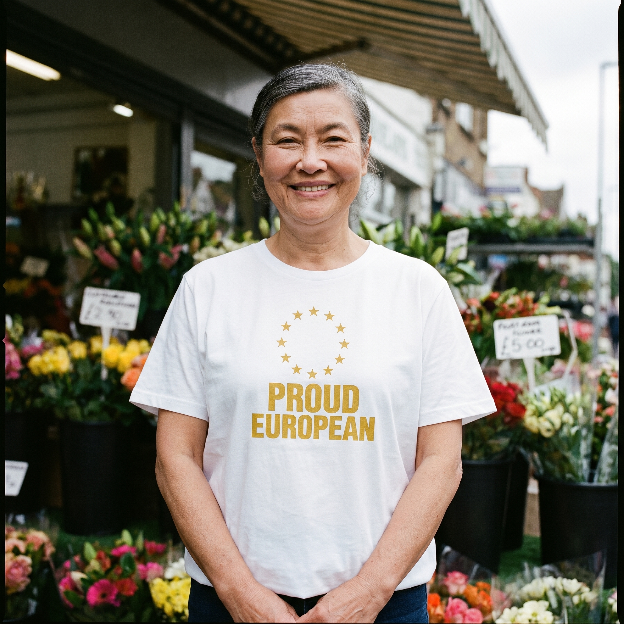 Woman in a white Proud European t-shirt at a flower stall, Very Brexit Problems