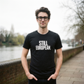 Man in a black heather Still European t-shirt on a riverside walkway, Very Brexit Problems
