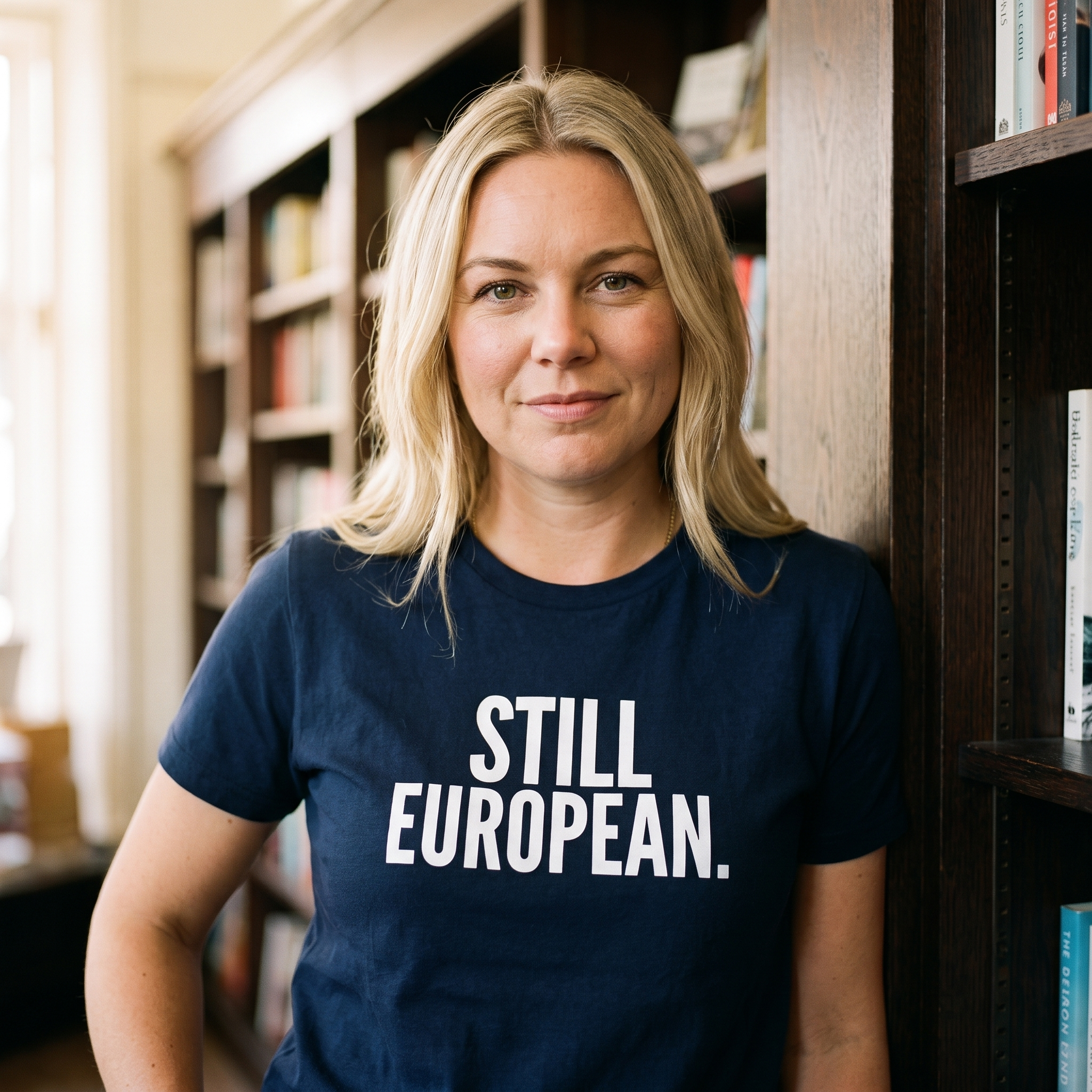 Woman in a navy Still European t-shirt in a bookshop, Very Brexit Problems