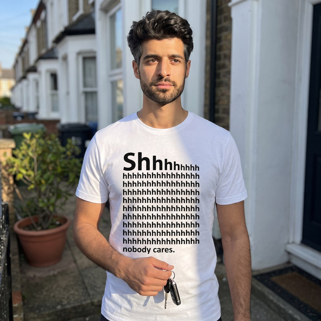 Man in a white Shhh Nobody Cares t-shirt on a front doorstep