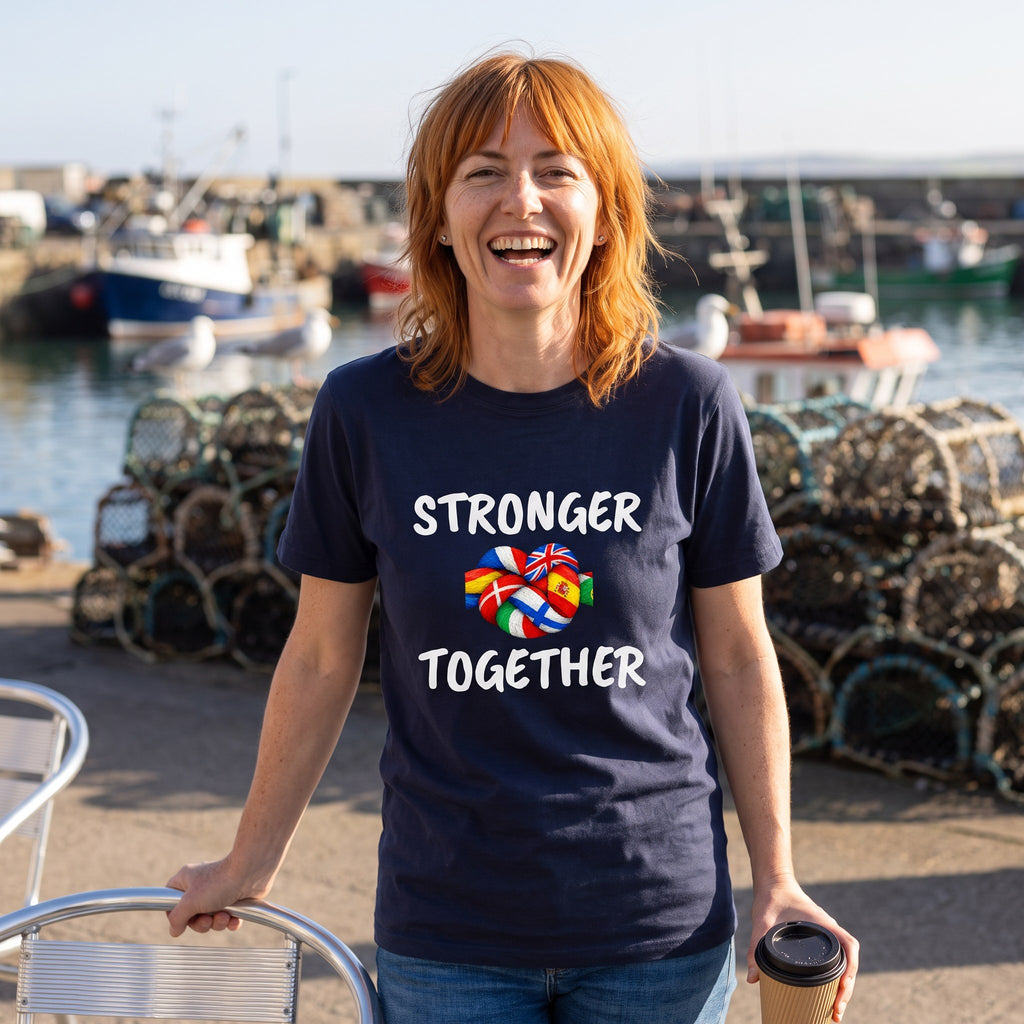 Woman laughing at a harbour wearing the navy Stronger Together t-shirt, a knot of flag-painted rope between the words