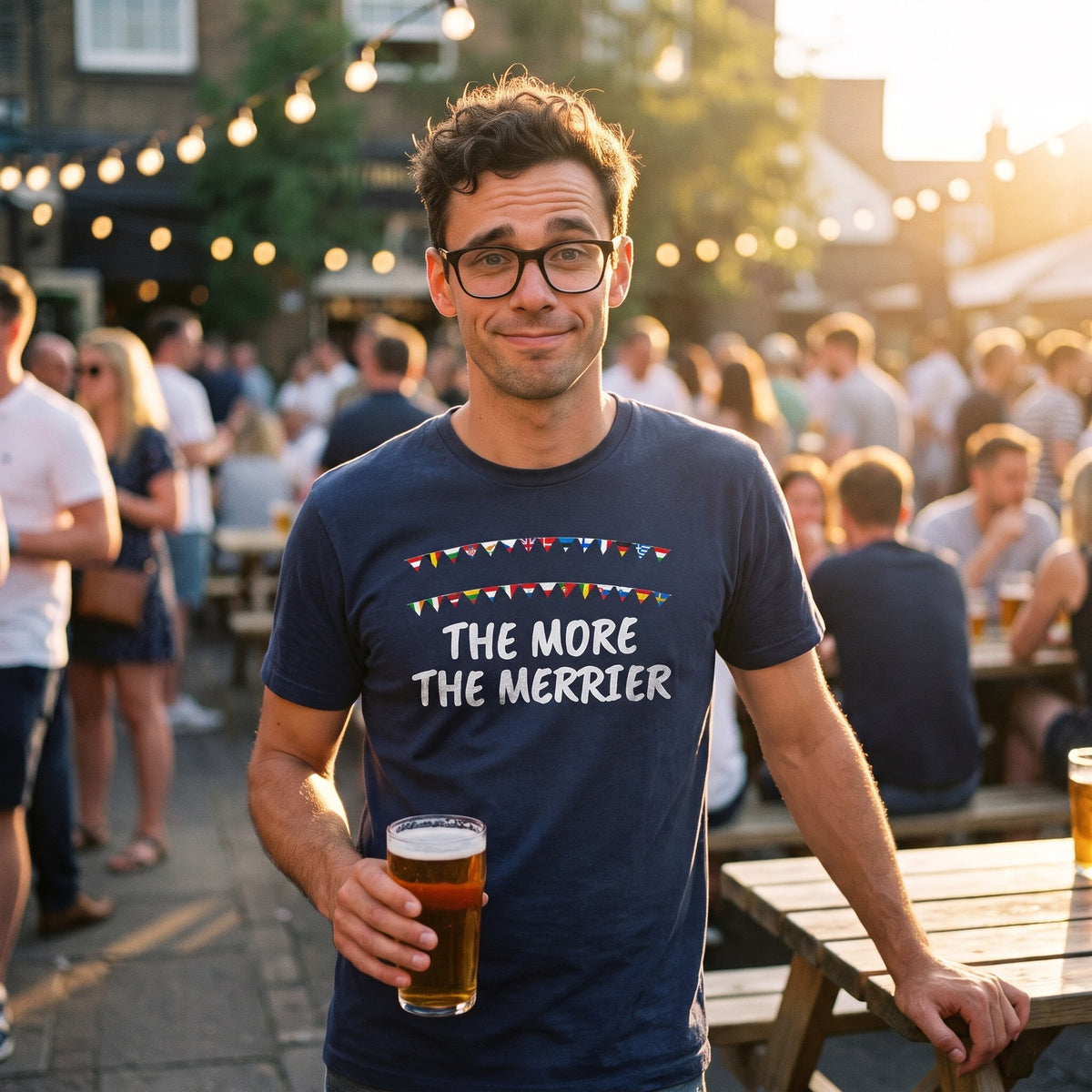 Man with a pint in a pub beer garden wearing the navy The More the Merrier pro-EU t-shirt