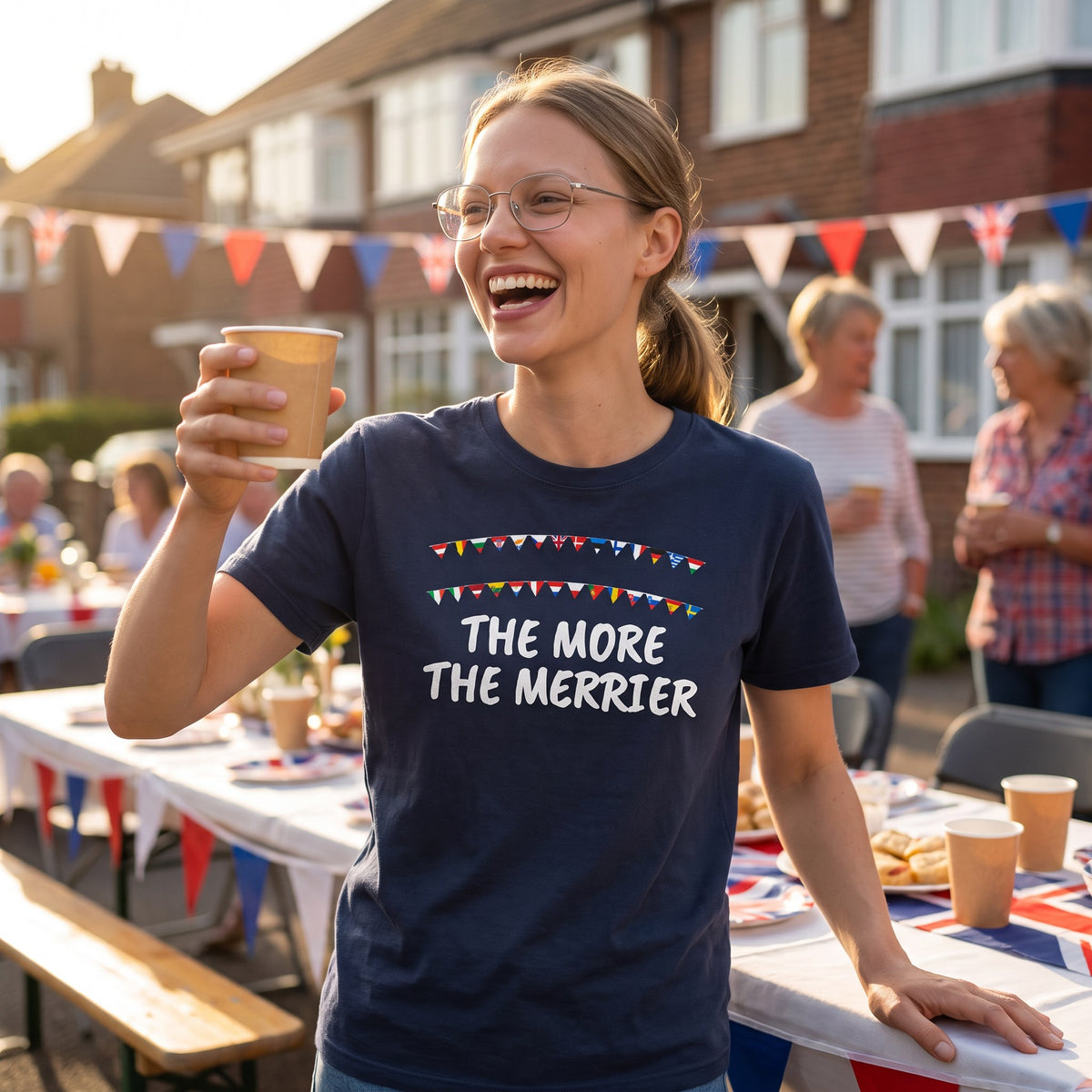 Woman laughing at a street party wearing the navy The More the Merrier t-shirt with European flag bunting