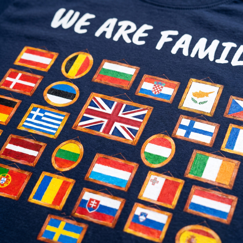 Close-up of the We Are Family print on a navy t-shirt, 28 hand-painted flags in picture frames, showing cotton texture and ink detail