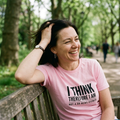 Woman laughing on a park bench in the pink I Think Therefore I Am Not a GB News Viewer t-shirt, print legible, Very Brexit Problems