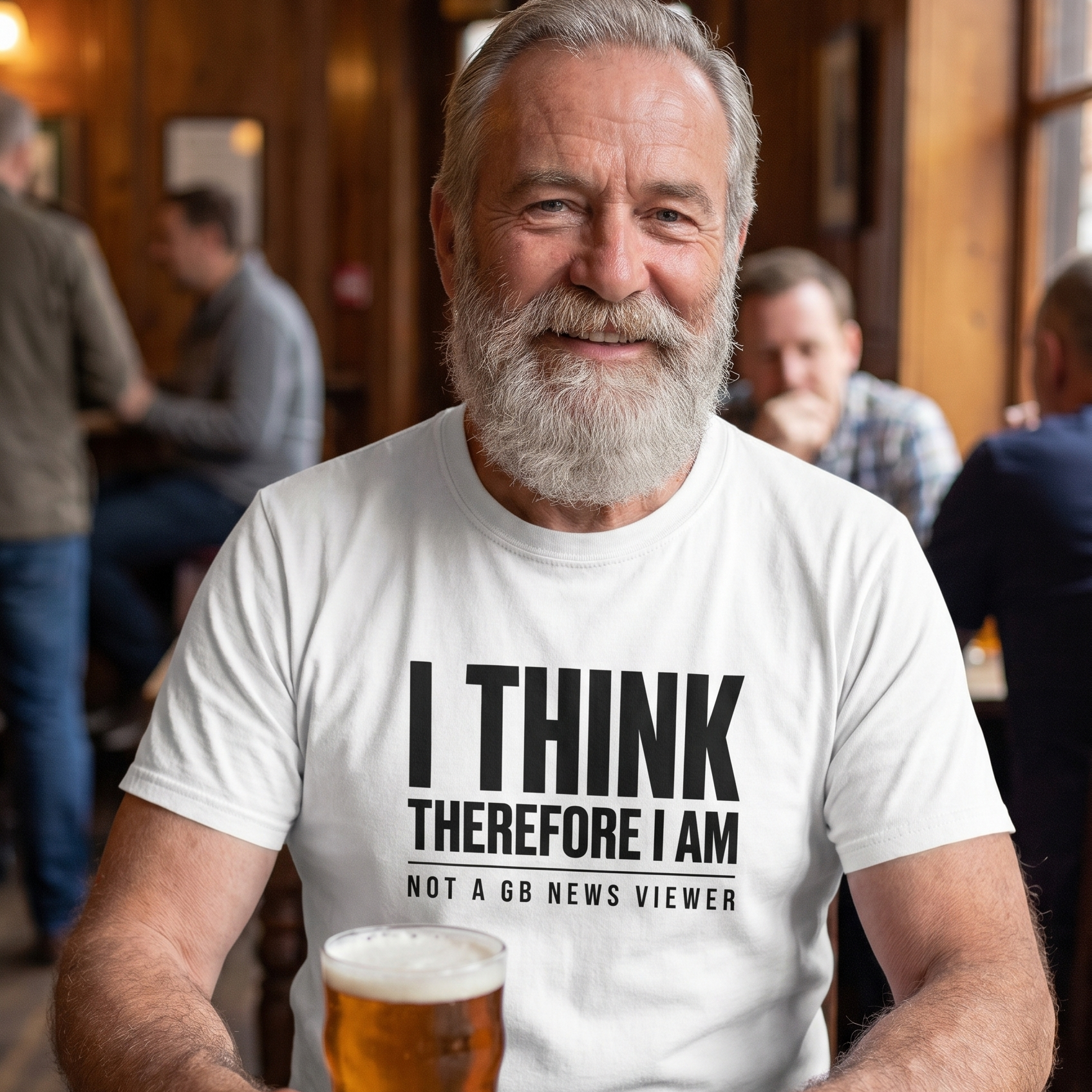 Man with a grey beard enjoying a pint in a pub in the white I Think Therefore I Am Not a GB News Viewer t-shirt, Very Brexit Problems