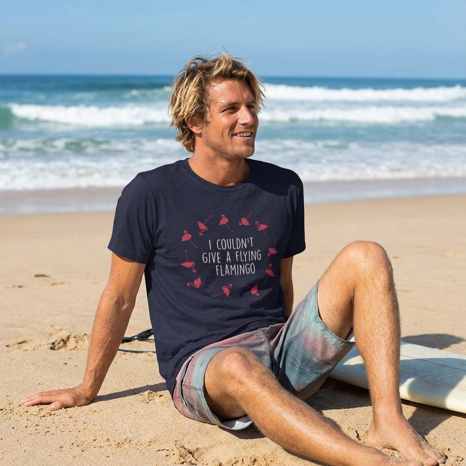 Man sitting on the beach in the navy I Couldn't Give a Flying Flamingo t-shirt, print close and legible, Very Brexit Problems