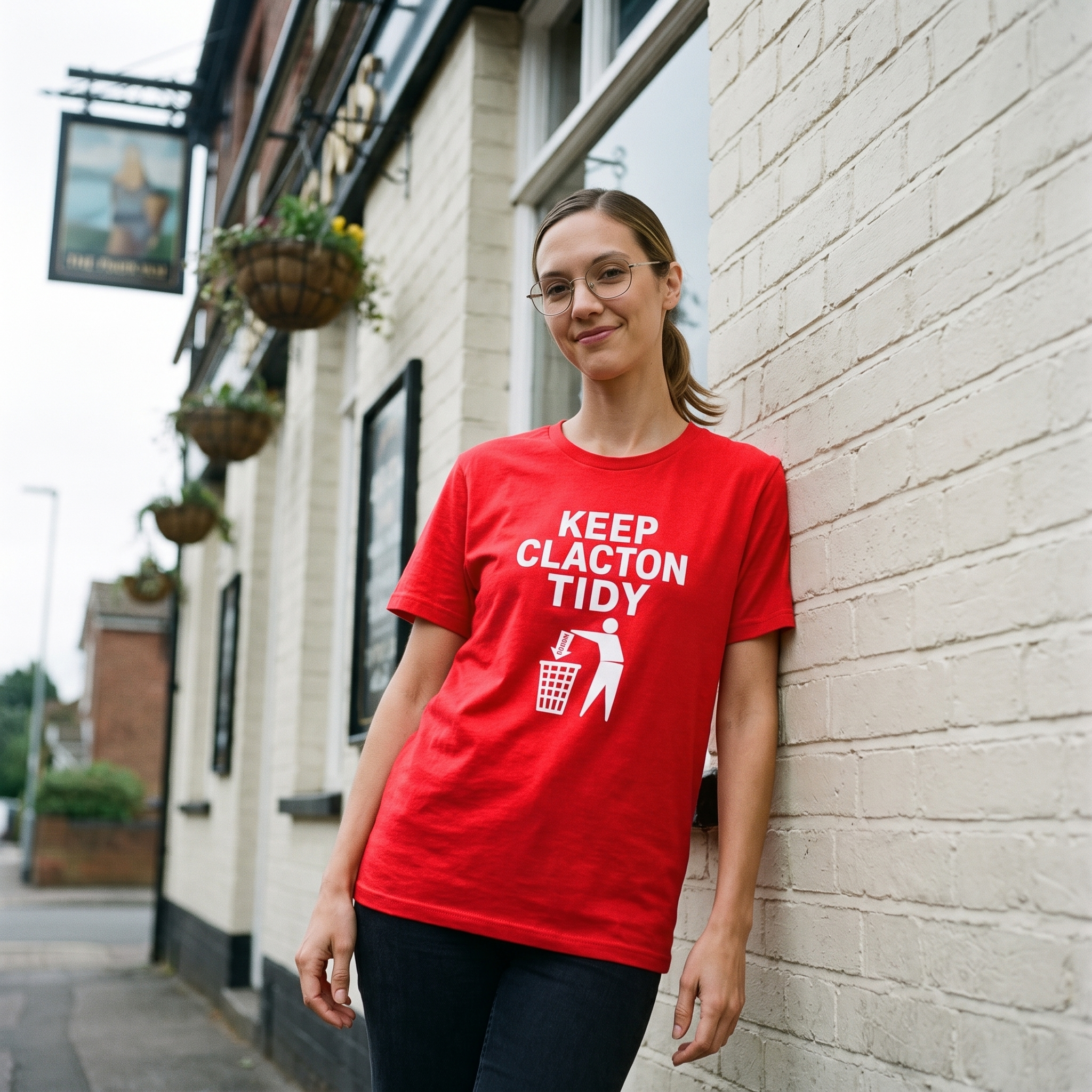 Woman in a red Keep Clacton Tidy t-shirt outside a pub on a corner, Very Brexit Problems